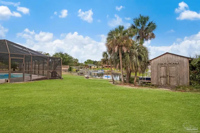 a backyard of a house with table and chairs