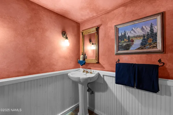 a spacious bathroom with a granite countertop sink a mirror and a shower