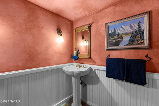 a spacious bathroom with a granite countertop sink a mirror and a shower