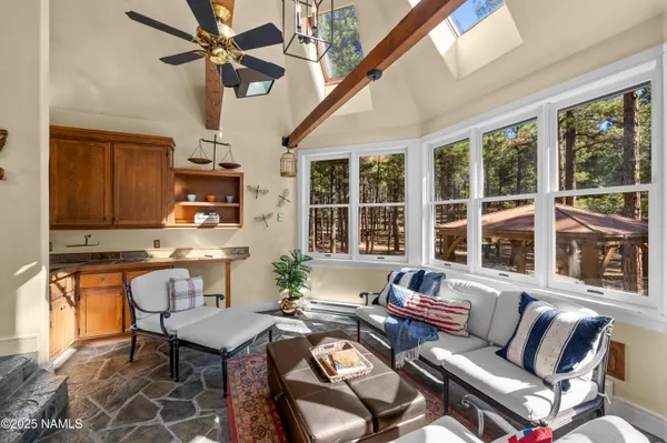a bedroom with a bed couch and a large window