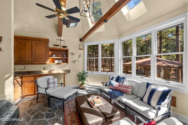 a bedroom with a bed couch and a large window