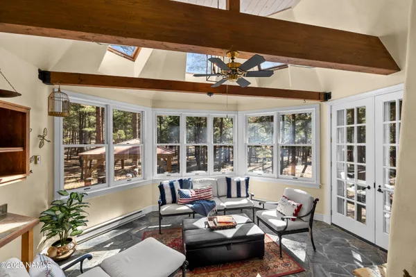 a bedroom with a bed and a large window with the outer view