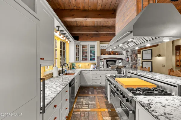 a dining room with furniture and a floor to ceiling window