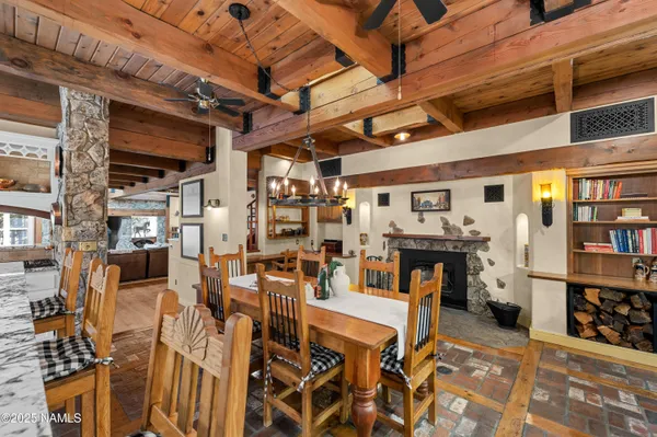 a view of a patio with table and chairs and a large tree
