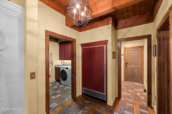 a view of swimming pool with large trees and wooden fence