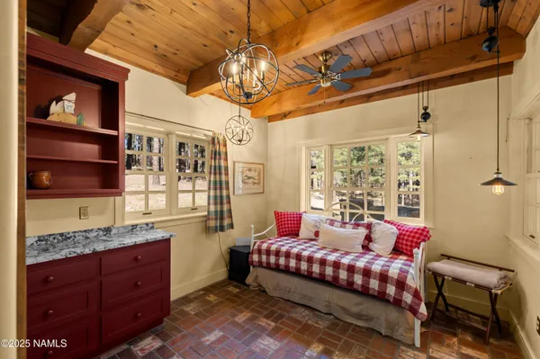 a wooden house with trees in the background