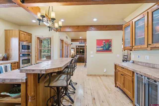 a view of a dining room with furniture and a chandelier