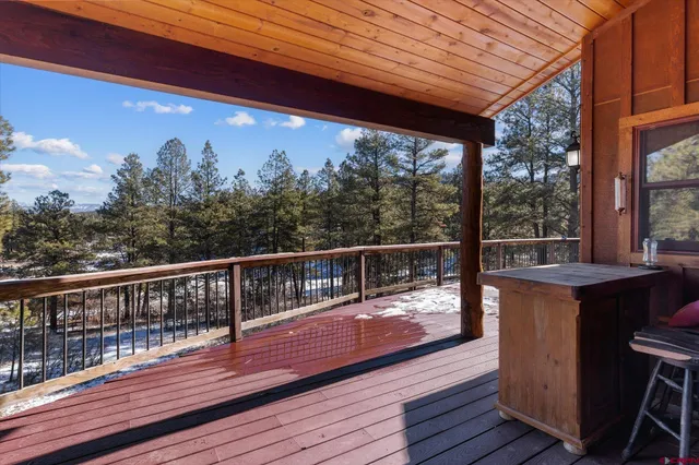 a view of balcony with wooden floor and fence