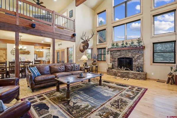 a living room with furniture hard wood floor and a rug