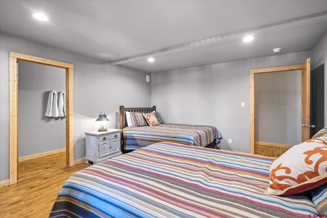 a bedroom with bed and wooden floor