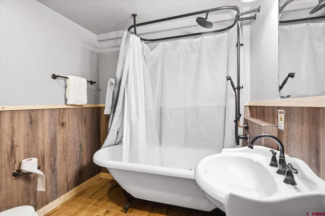 a bathroom with a sink a mirror and a shower