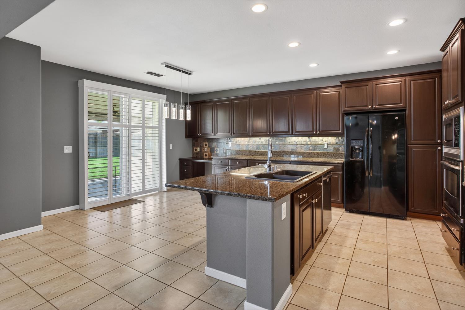 2042 Danforth Way Plumas Lake, CA 95961 - Photo 13 of 56 a kitchen with kitchen island granite countertop a sink and a stove