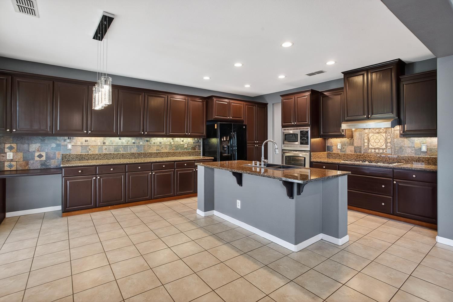 2042 Danforth Way Plumas Lake, CA 95961 - Photo 14 of 56 a kitchen with stainless steel appliances granite countertop a stove sink and cabinets