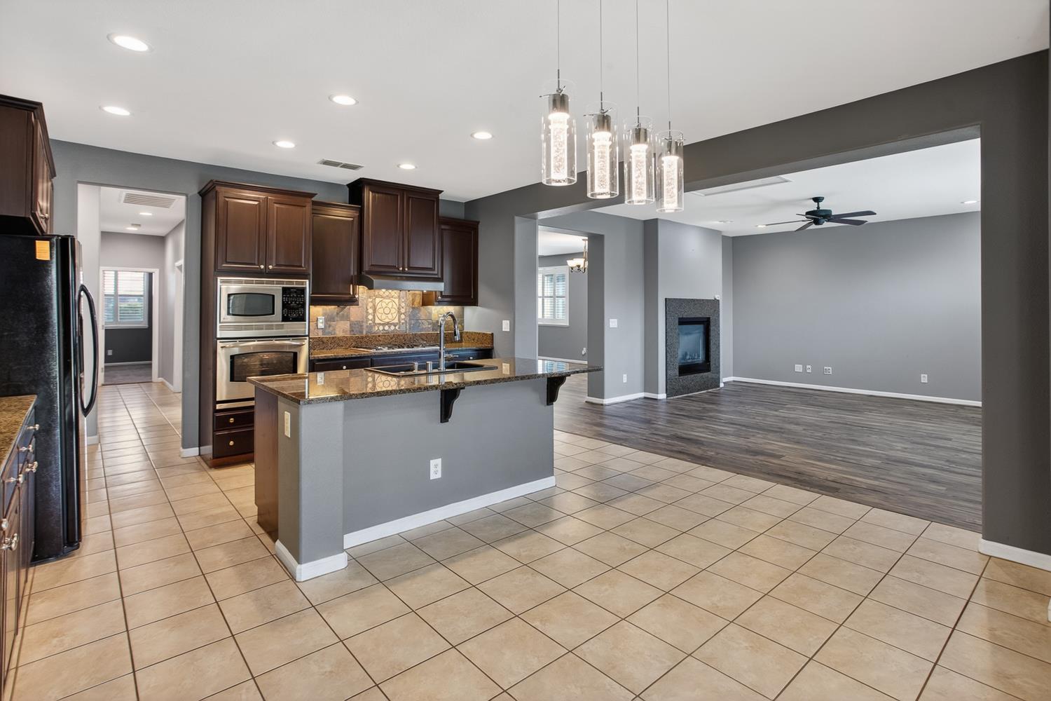 2042 Danforth Way Plumas Lake, CA 95961 - Photo 17 of 56 a kitchen with stainless steel appliances kitchen island granite countertop a refrigerator and a sink