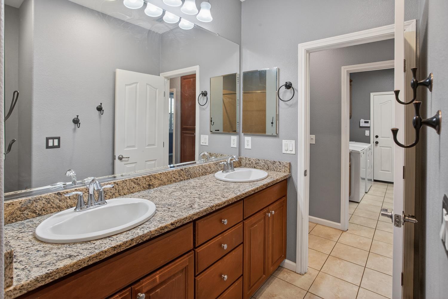 2042 Danforth Way Plumas Lake, CA 95961 - Photo 30 of 56 a bathroom with a granite countertop sink and a mirror