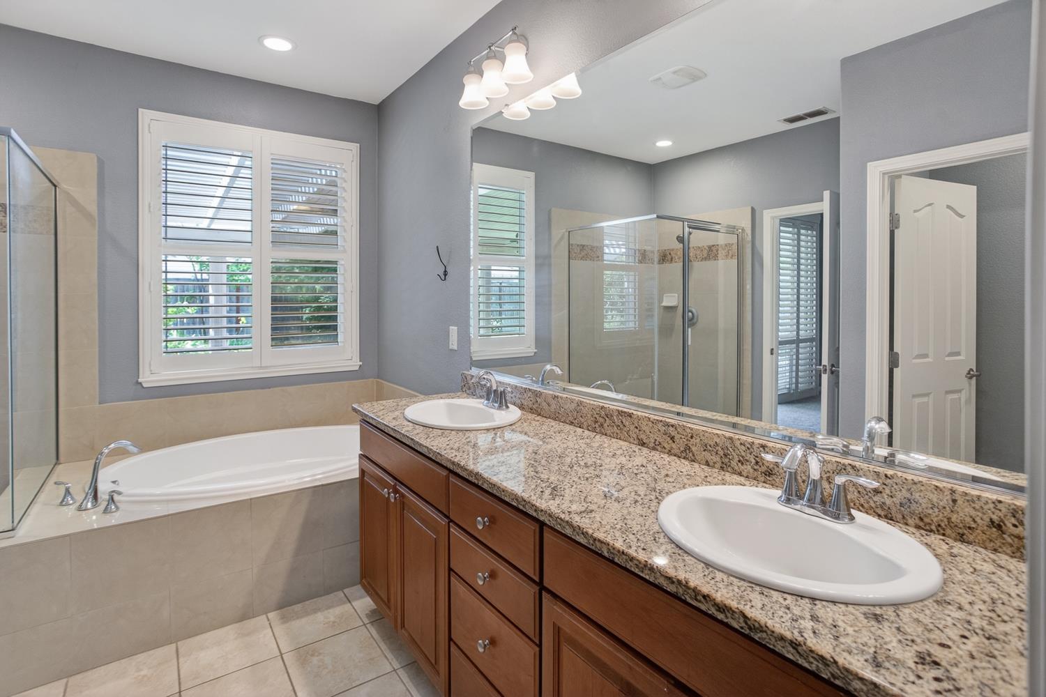 2042 Danforth Way Plumas Lake, CA 95961 - Photo 39 of 56 a bathroom with a granite countertop tub sink and mirror