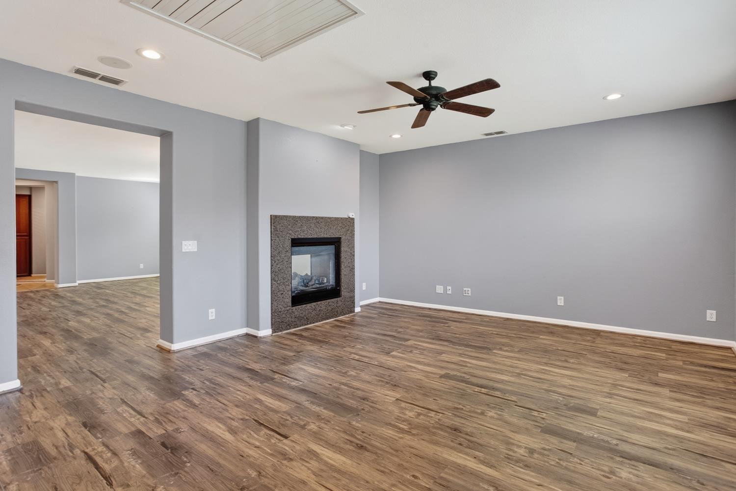 2042 Danforth Way Plumas Lake, CA 95961 - Photo 8 of 56 Family room looking into Dining/living shows the see through 2 sided glass fireplace