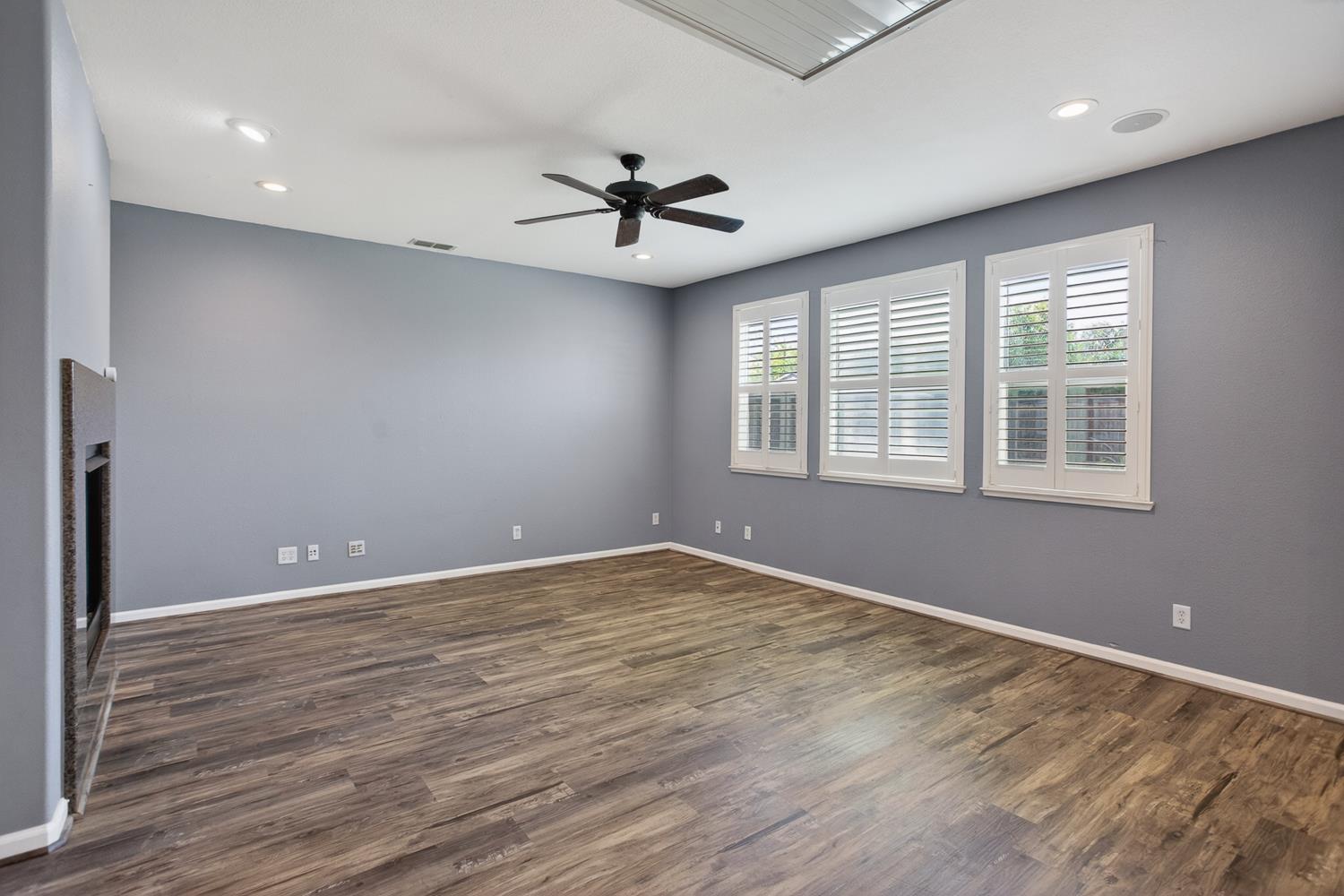 2042 Danforth Way Plumas Lake, CA 95961 - Photo 9 of 56 an empty room with wooden floor ceiling fan and windows