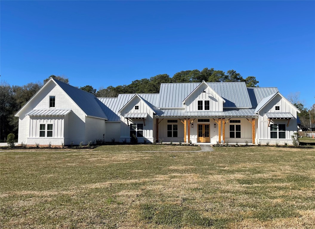 18248 Woodstream Crossing Road Montgomery, TX 77316 - Photo 8 of 8 a front view of a house with a garden
