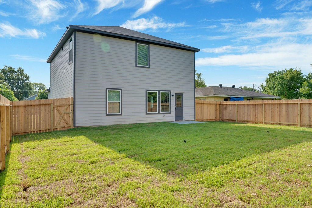 2012 Bellview Street Texas City, TX 77568 - Photo 22 of 23 a view of a backyard with plants and wooden fence