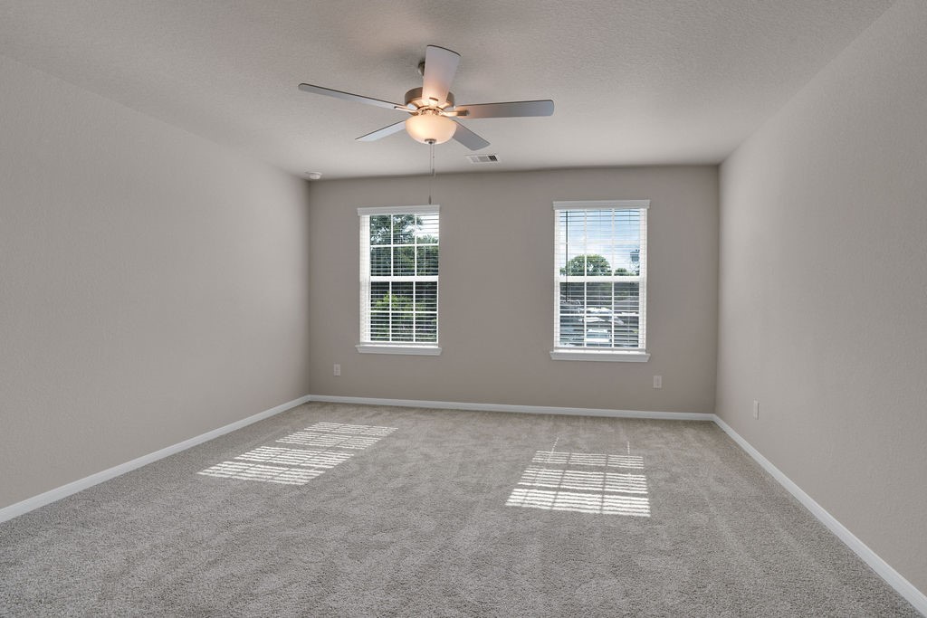 2012 Bellview Street Texas City, TX 77568 - Photo 7 of 23 an empty room with windows and fan