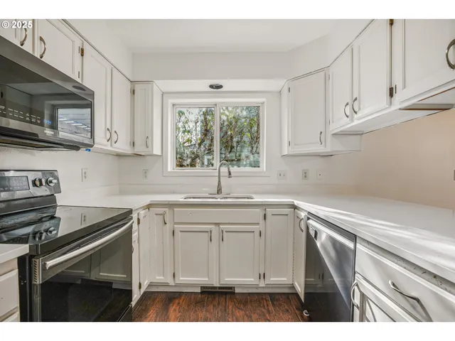 a kitchen with appliances cabinets and a sink