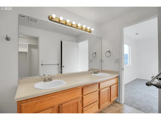 a bathroom with a sink double vanity and a mirror