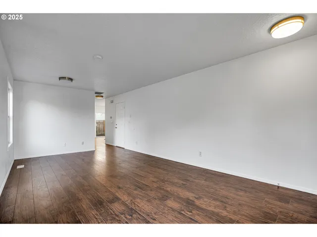 a view of an empty room and wooden floor