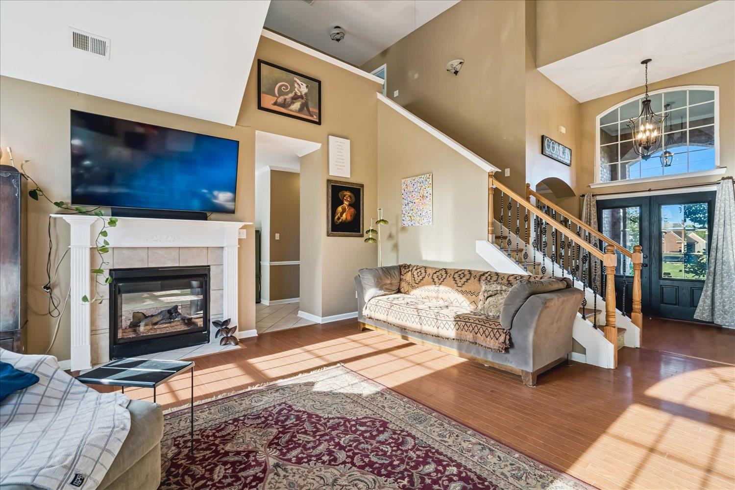 134 Rembert Drive Atoka, TN 38004 - Photo 12 of 28 a living room with a balcony furniture a flat screen tv and a fireplace