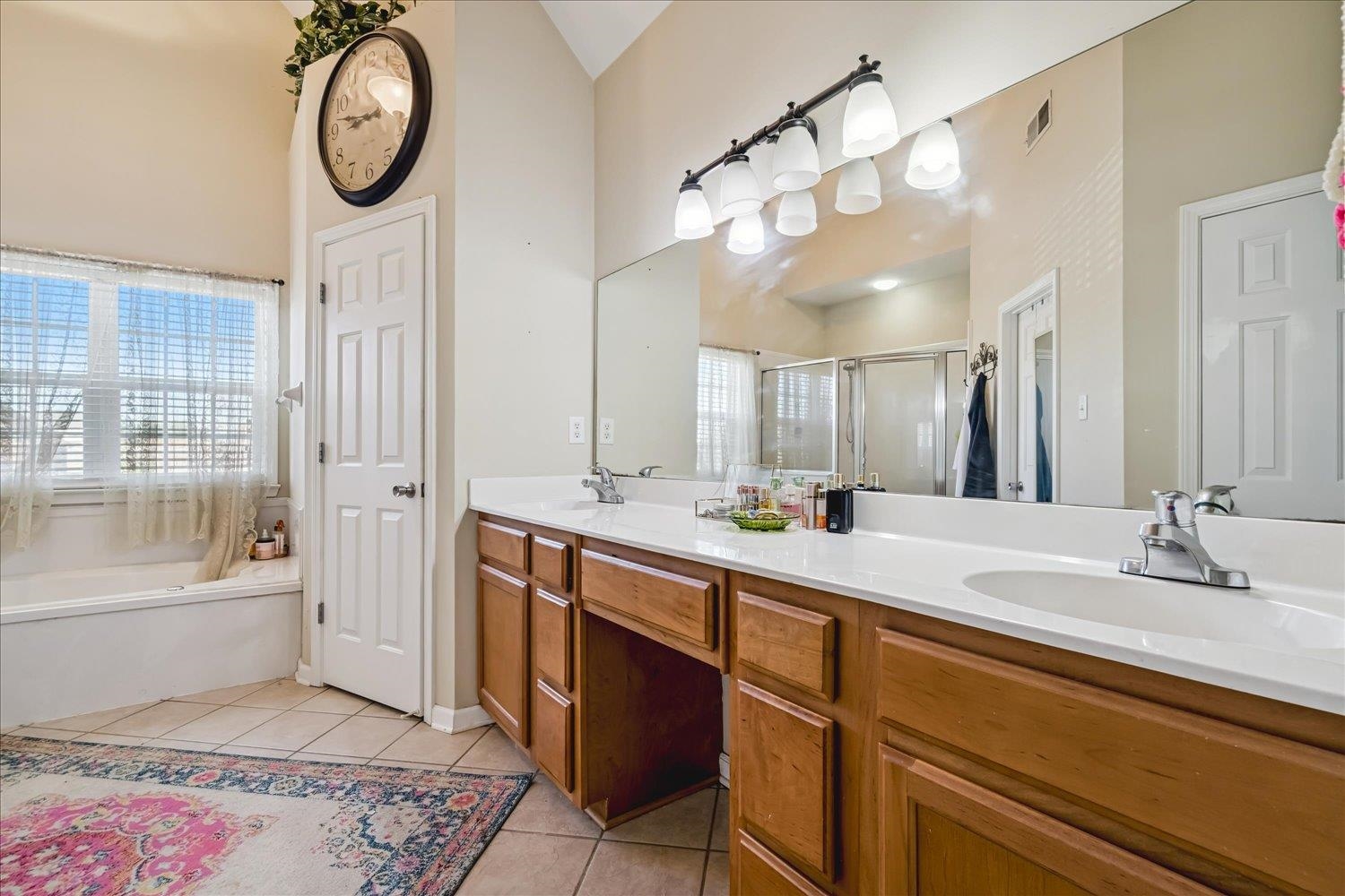 134 Rembert Drive Atoka, TN 38004 - Photo 20 of 28 a spacious bathroom with a double vanity sink mirror and a bathtub