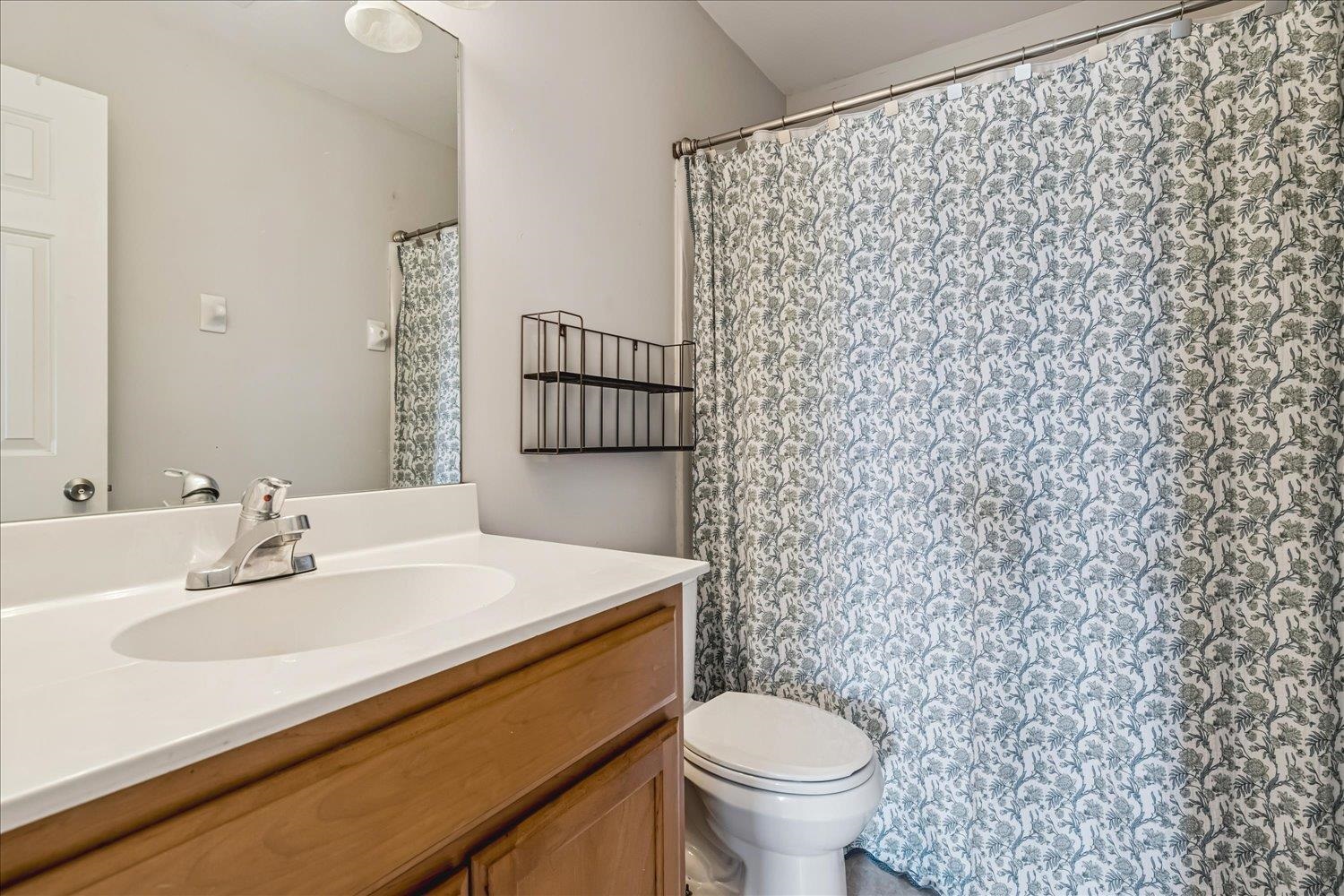 134 Rembert Drive Atoka, TN 38004 - Photo 21 of 28 a bathroom with a sink a toilet and a mirror