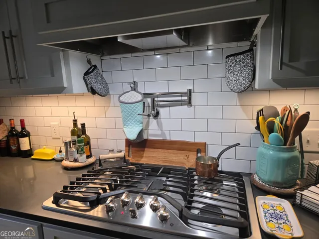 a table with wine bottles and glasses