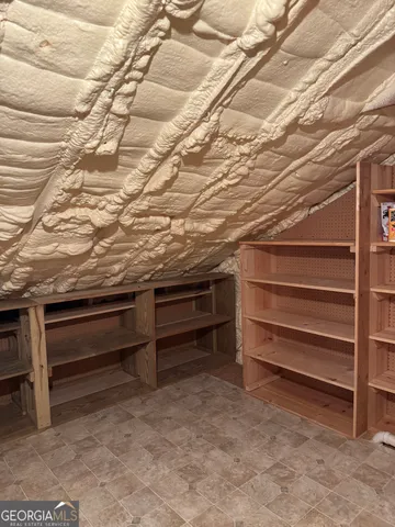 a house is sitting in middle of the green field