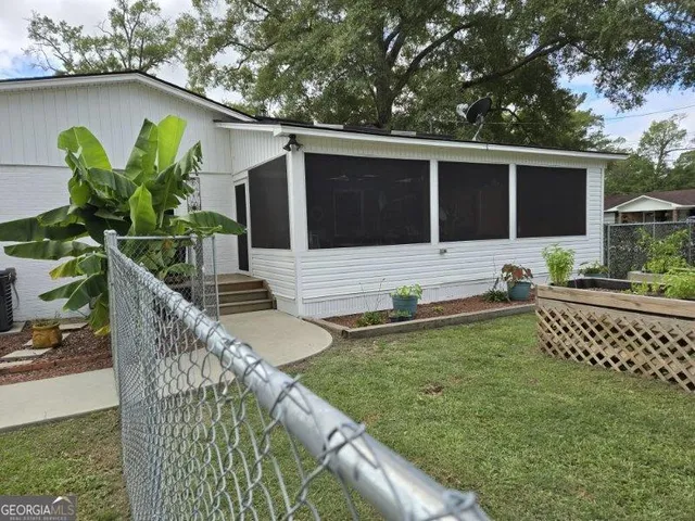 a view of a house with a yard and a garden