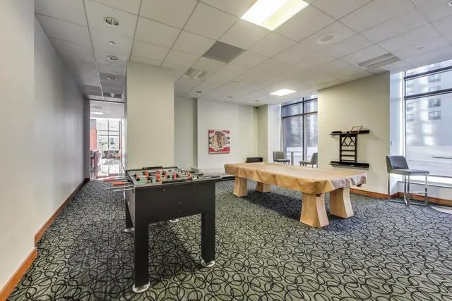 a large kitchen with a table and chairs in it