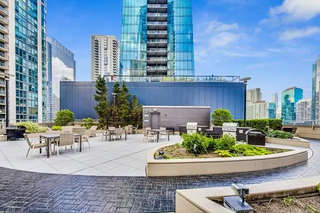a view of a patio with couches table and chairs and potted plants