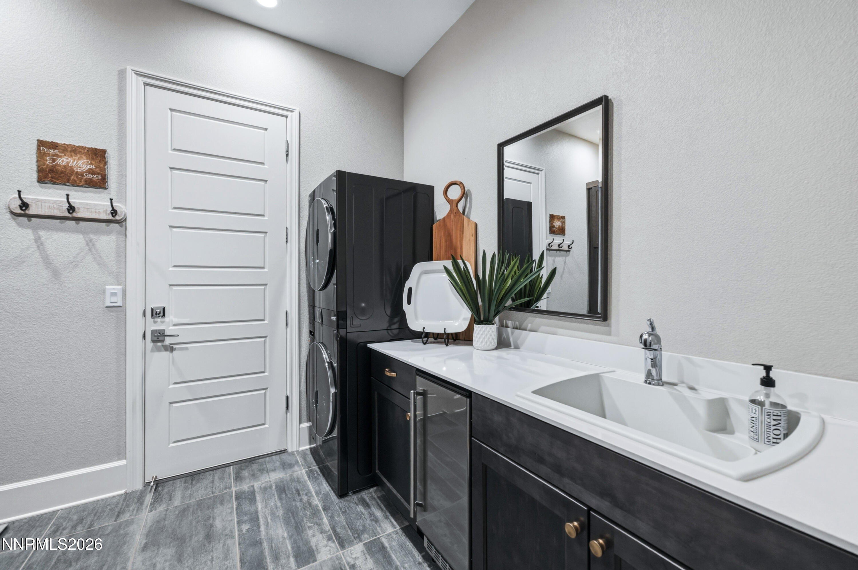 9028 Iron Sky Court Reno, NV 89523 - Photo 27 of 36 a bathroom with a double vanity sink and mirror