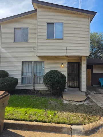 a view of a house with a yard and garage