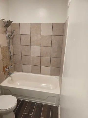 a bathroom with a bathtub and sink