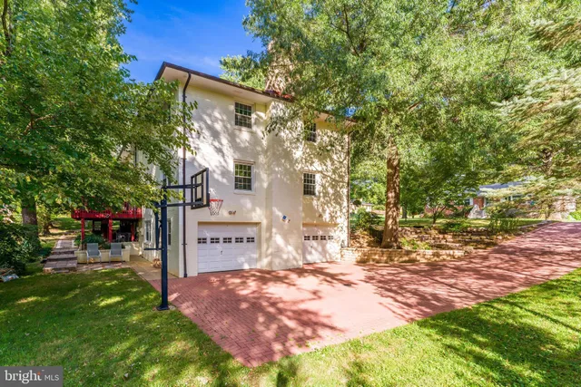 a backyard of a house with table and chairs