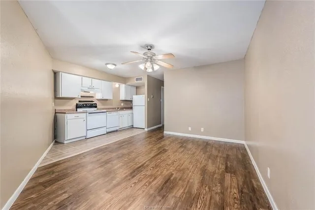 a view of a kitchen with wooden floor and a kitchen