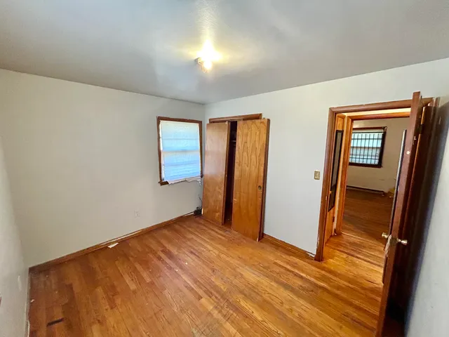 wooden floor in an empty room with a window