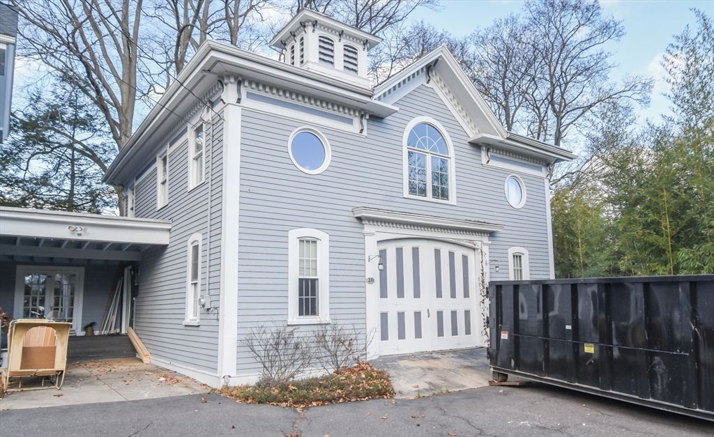 a view of a house with a small space and wooden fence