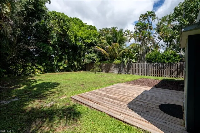 a view of swimming pool with lawn chairs and couches