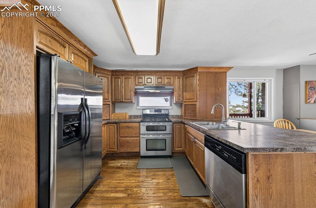 3785 Overlook Road Colorado Springs, CO 80906 - Photo 11 of 45 a kitchen with stainless steel appliances granite countertop a sink stove and refrigerator