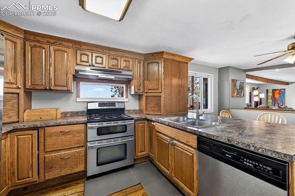 3785 Overlook Road Colorado Springs, CO 80906 - Photo 14 of 45 a kitchen with granite countertop cabinets stainless steel appliances and a counter space