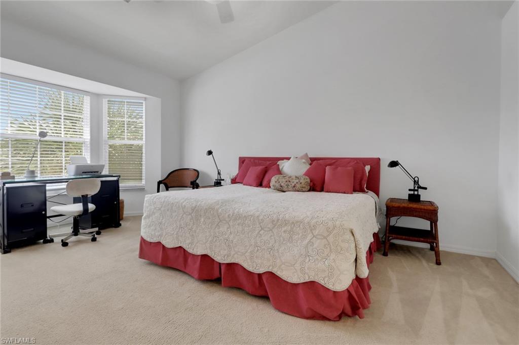 6180 Reserve Circle, Unit 203 Naples, FL 34119 - Photo 12 of 26 Primary bedroom with vaulted ceiling and two closets (one walk in)