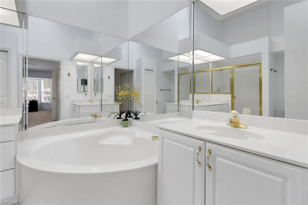 6180 Reserve Circle, Unit 203 Naples, FL 34119 - Photo 13 of 26 Primary bath featuring a large shower, soaking tub, two vanities and a linen closet