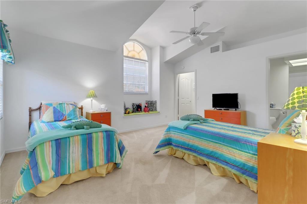 6180 Reserve Circle, Unit 203 Naples, FL 34119 - Photo 15 of 26 Guest bedroom #2 with vaulted ceiling, walk in closet, en suite bathroom