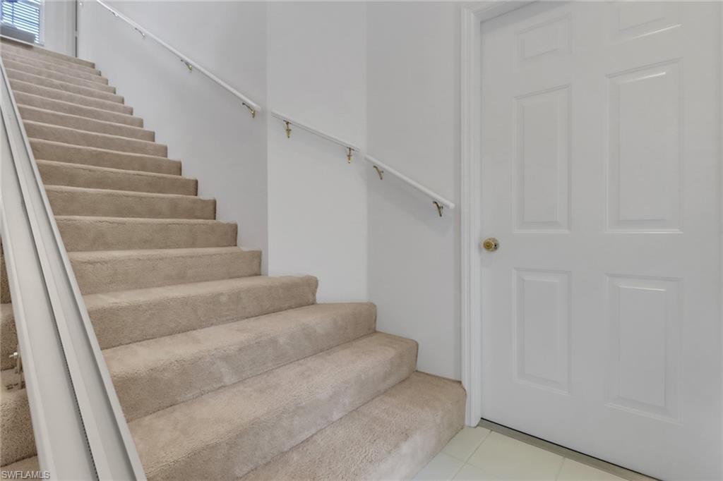 6180 Reserve Circle, Unit 203 Naples, FL 34119 - Photo 23 of 26 Stairway leading from foyer to living space